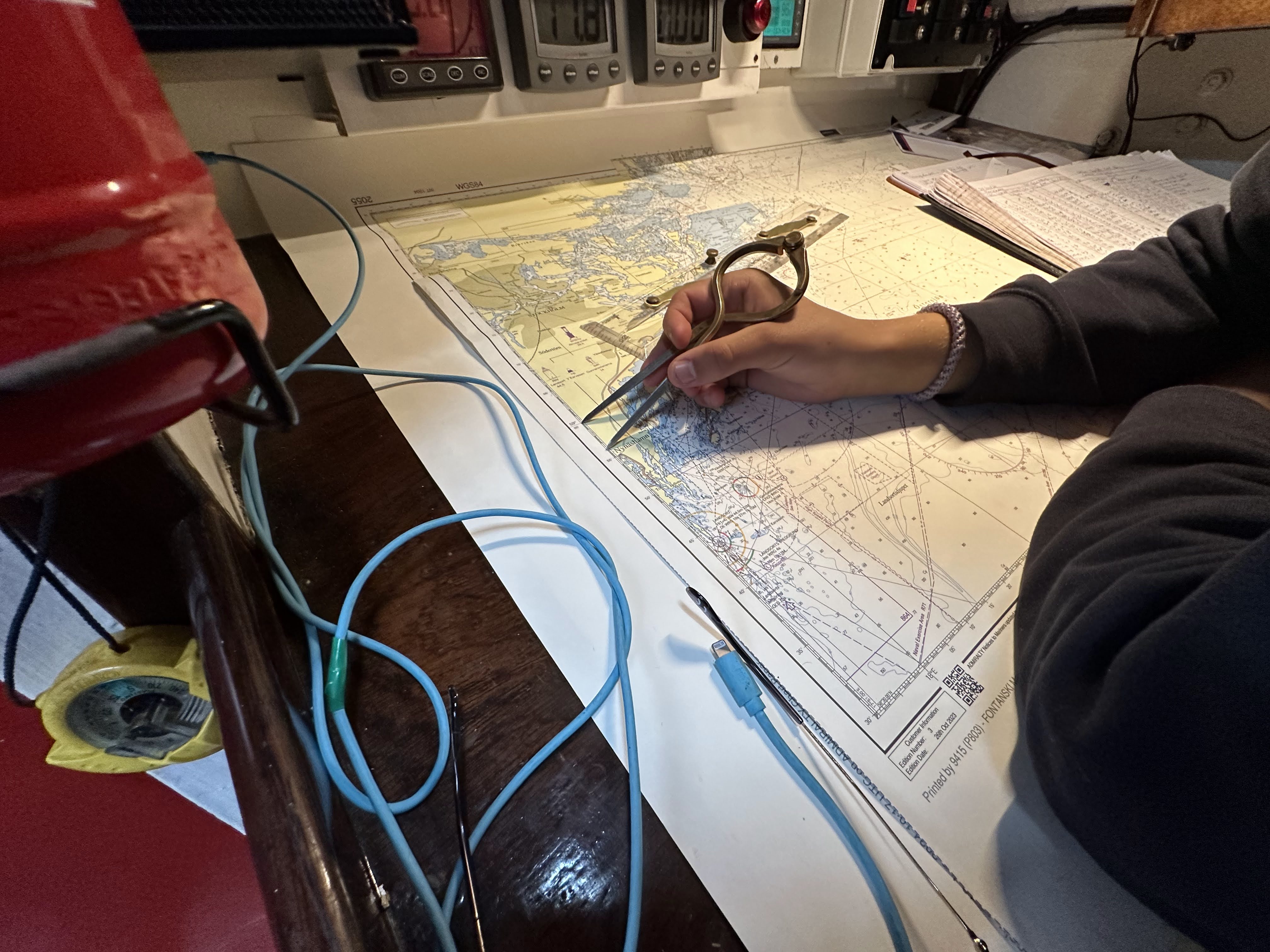 Plotting our course at night under the red chart light